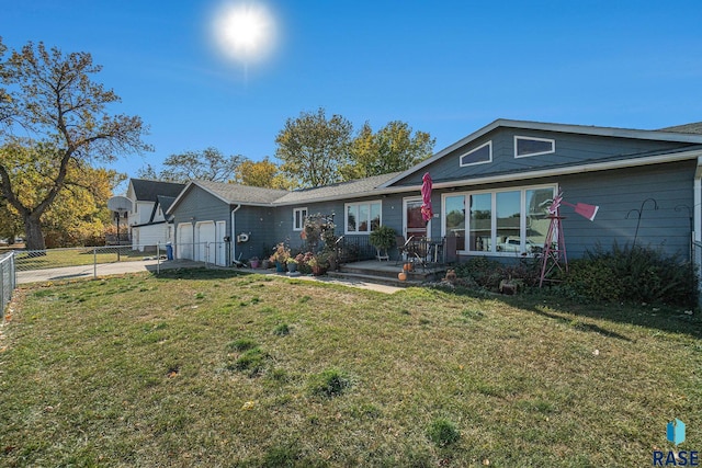 ranch-style house featuring a front yard and a garage