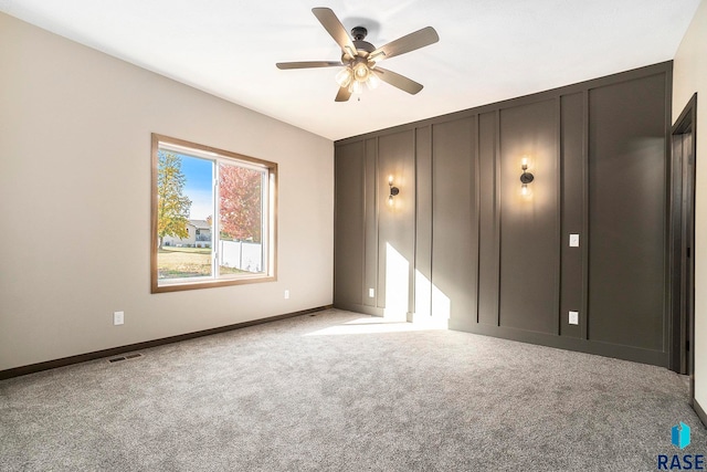 unfurnished room featuring light carpet and ceiling fan