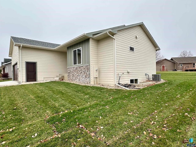 view of home's exterior with a garage and a yard