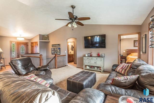 living room with ceiling fan, lofted ceiling, and light colored carpet