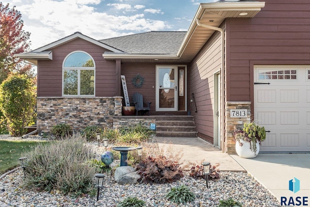 view of exterior entry with a garage