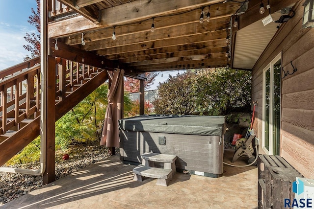 view of patio / terrace with a hot tub