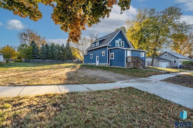 view of side of home with a yard