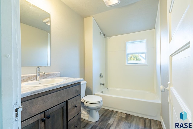 full bathroom with  shower combination, a textured ceiling, toilet, vanity, and hardwood / wood-style flooring