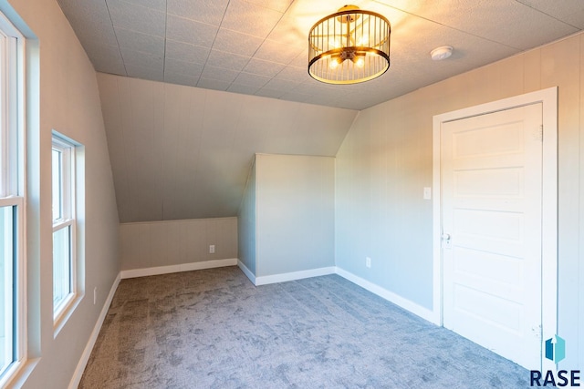 bonus room with lofted ceiling and carpet floors