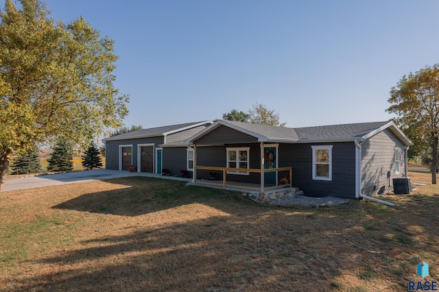 ranch-style home with a front yard and central AC