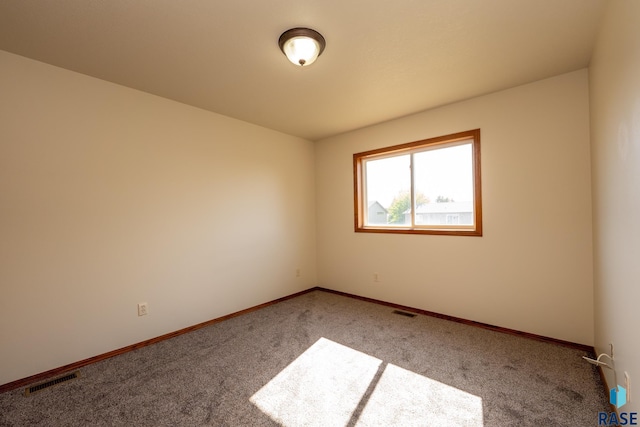 unfurnished room featuring light colored carpet