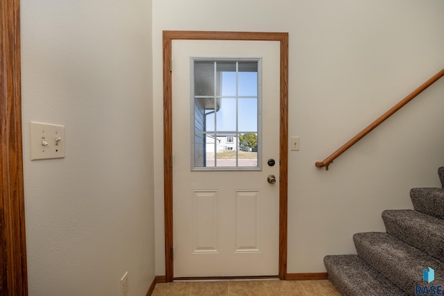 doorway to outside with light tile patterned floors