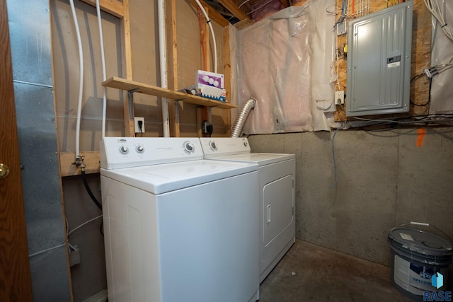 clothes washing area featuring washing machine and clothes dryer and electric panel