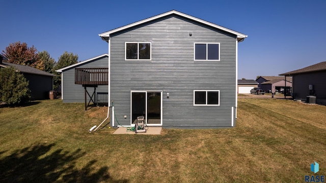 back of property with a lawn and a wooden deck