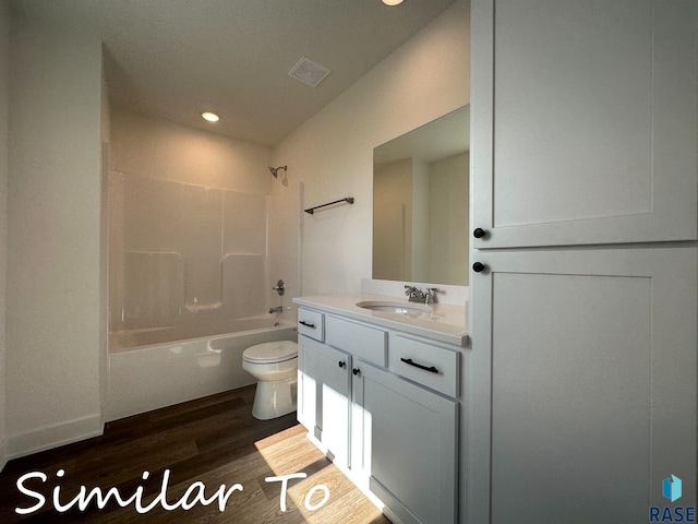 full bathroom featuring hardwood / wood-style flooring, toilet, bathtub / shower combination, and vanity