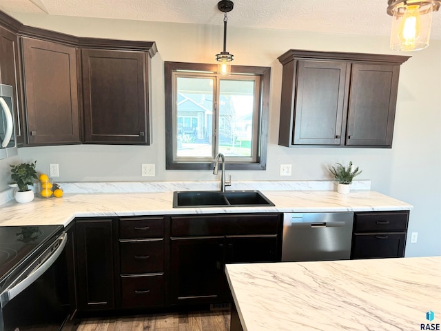 kitchen with pendant lighting, sink, dark brown cabinetry, and stainless steel appliances