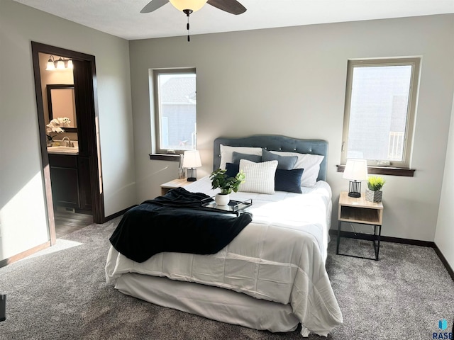 carpeted bedroom featuring ceiling fan, sink, and ensuite bathroom