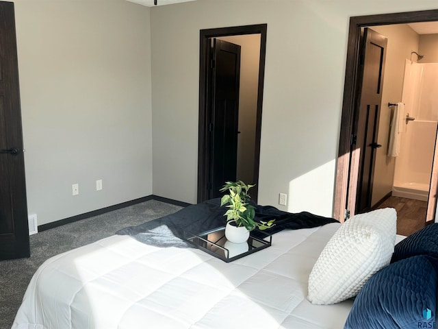 carpeted bedroom featuring ensuite bath