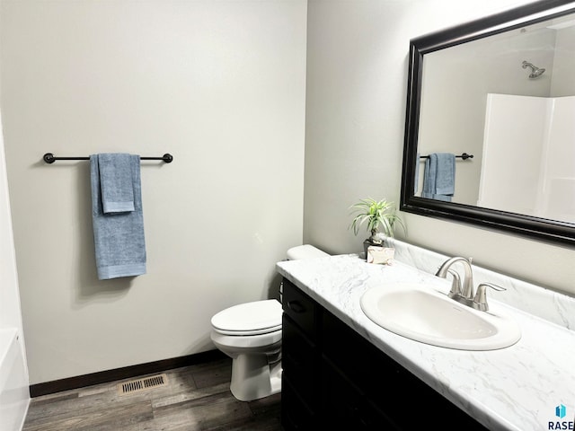 bathroom featuring hardwood / wood-style floors, vanity, and toilet