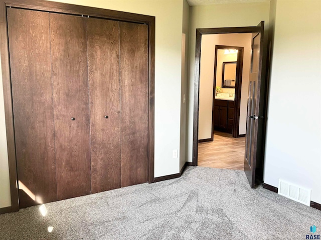 unfurnished bedroom featuring a closet and light hardwood / wood-style floors