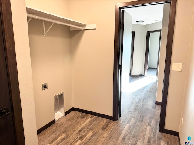 laundry room with electric dryer hookup and wood-type flooring