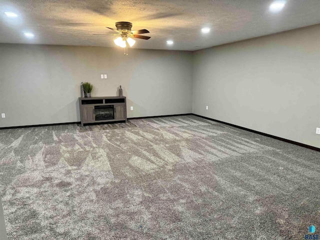 interior space featuring a textured ceiling and ceiling fan