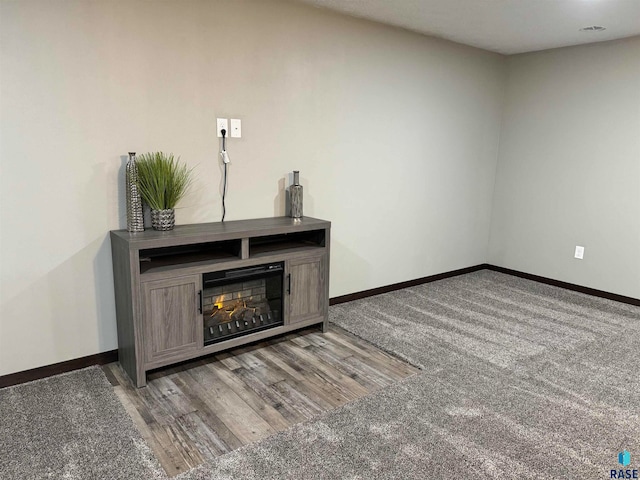 unfurnished living room featuring hardwood / wood-style flooring