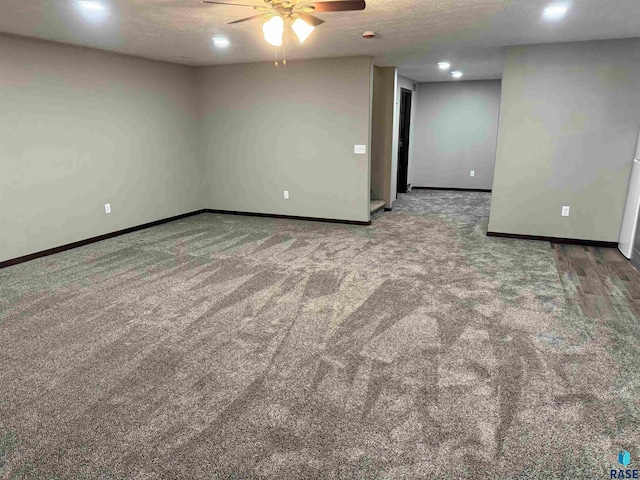 carpeted empty room featuring a textured ceiling and ceiling fan