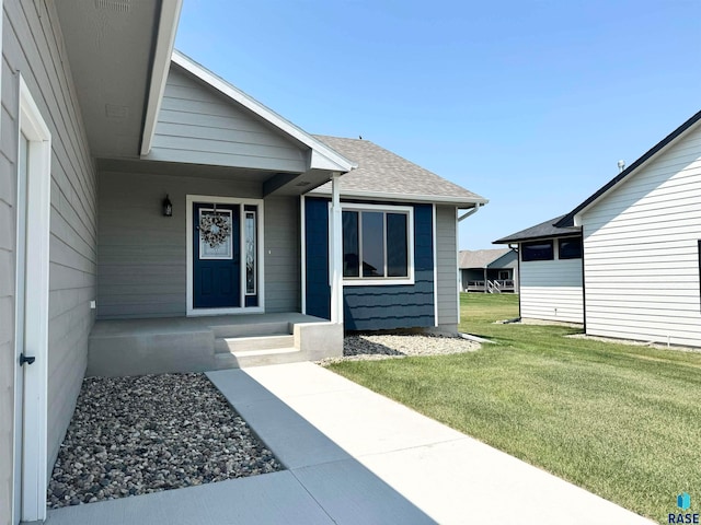 property entrance with a lawn