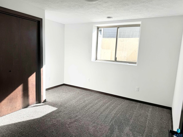 unfurnished bedroom featuring carpet flooring and a textured ceiling