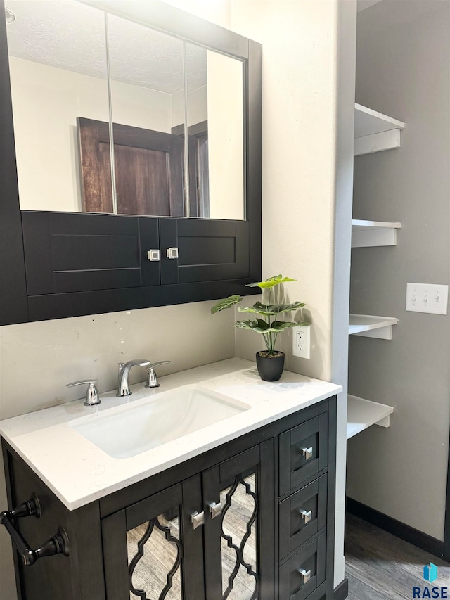 bathroom with vanity and hardwood / wood-style flooring