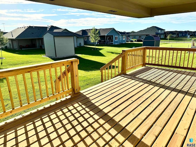 deck with a yard and a storage shed