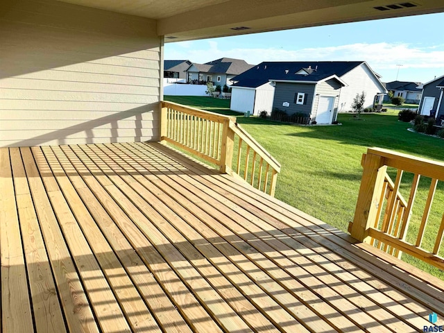 wooden deck featuring a storage shed and a yard