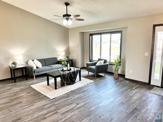 living room featuring ceiling fan, hardwood / wood-style floors, and a textured ceiling