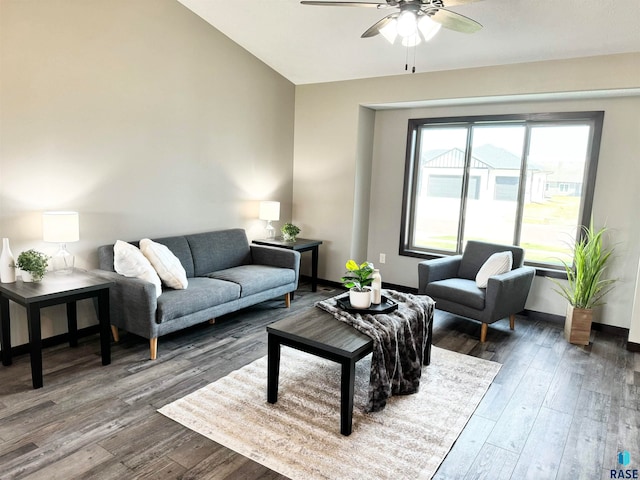 living room featuring vaulted ceiling, ceiling fan, and dark hardwood / wood-style floors