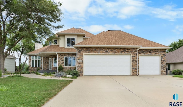 view of front of house with a front yard and a garage