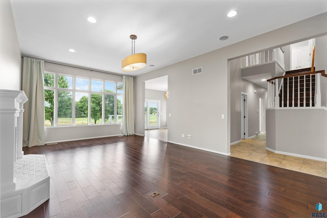 unfurnished living room featuring wood-type flooring