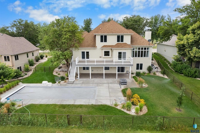 back of property with a yard, a carport, and a patio area