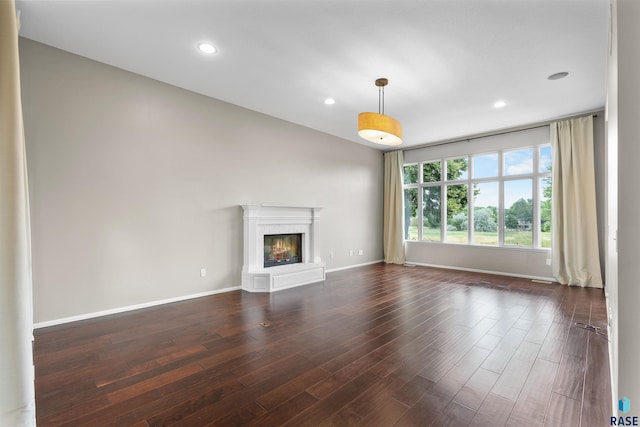 unfurnished living room with dark hardwood / wood-style floors