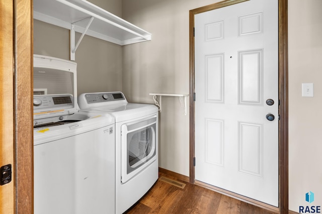 laundry area featuring dark wood-type flooring and independent washer and dryer