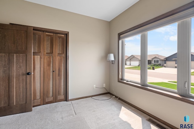 unfurnished bedroom featuring light colored carpet