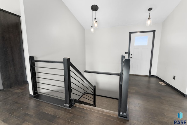 foyer entrance featuring lofted ceiling and dark hardwood / wood-style flooring