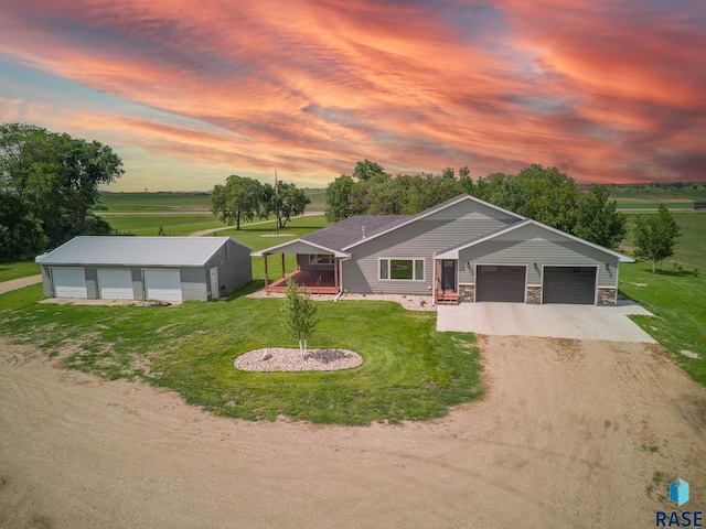 ranch-style home with a yard and a garage