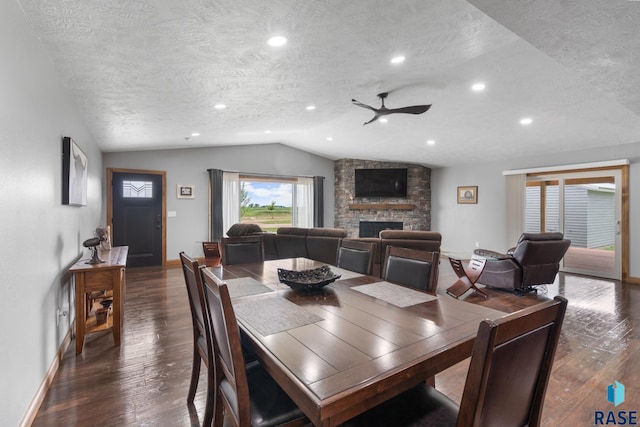 dining room with lofted ceiling, dark wood-type flooring, a textured ceiling, and ceiling fan