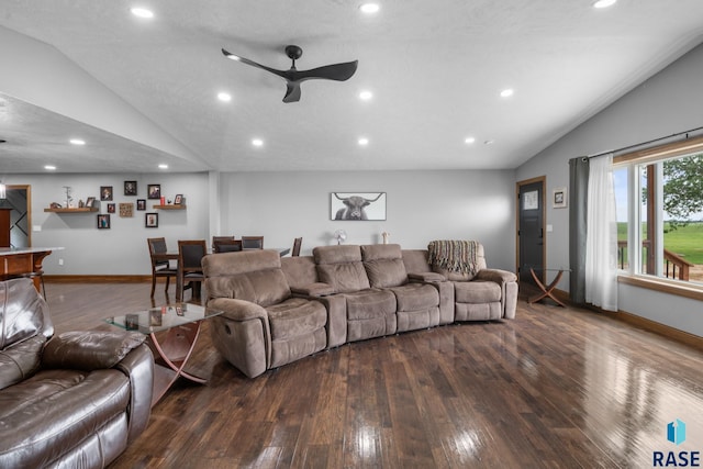 living room featuring vaulted ceiling, ceiling fan, a textured ceiling, and dark hardwood / wood-style flooring