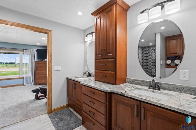 bathroom with vanity and a textured ceiling