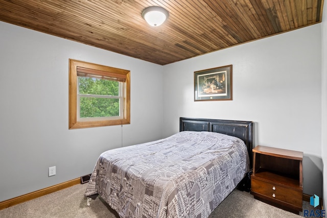 bedroom featuring wood ceiling and carpet floors