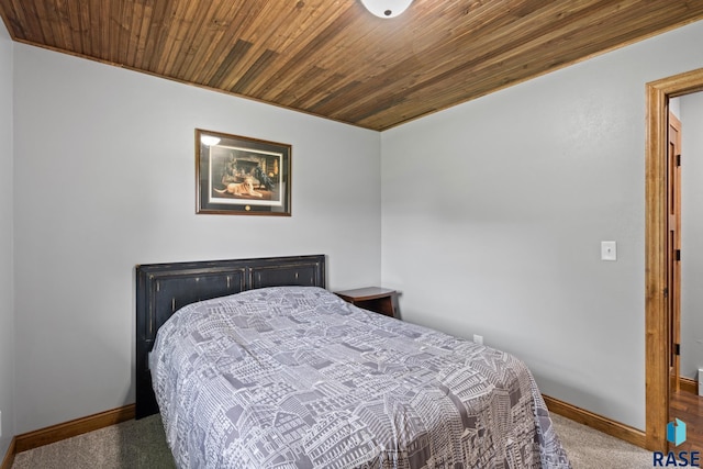 bedroom featuring wood ceiling and carpet flooring