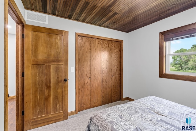 bedroom featuring carpet floors and wooden ceiling