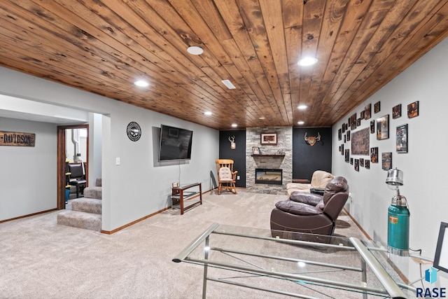 living room featuring a stone fireplace, carpet flooring, and wooden ceiling