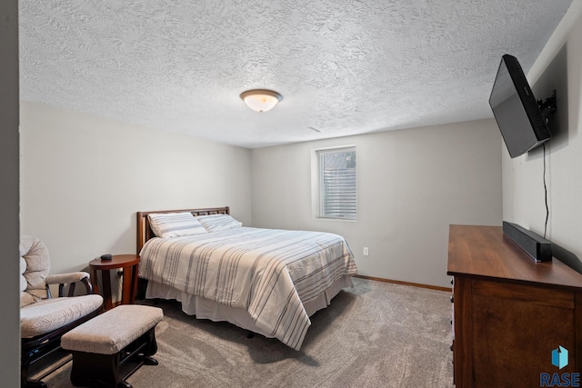 carpeted bedroom featuring a textured ceiling