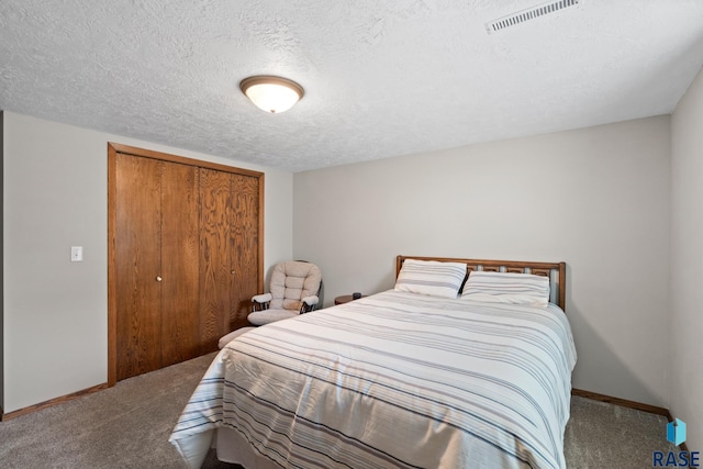 bedroom featuring a closet, carpet floors, and a textured ceiling