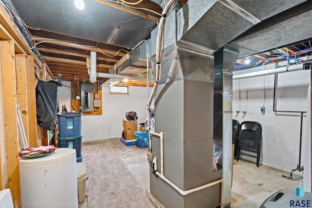 basement featuring electric panel and heating unit