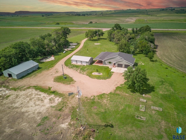 aerial view at dusk featuring a rural view